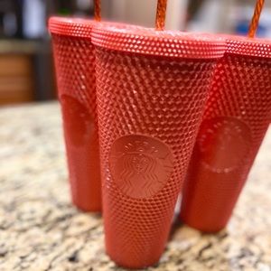 Orange Venti Starbucks cup